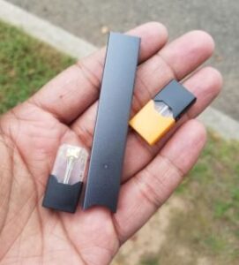 vaping devices in a hand