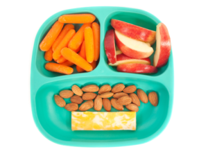 A green snack plate with baby carrots, , sliced apple, almonds, and marble cheese.
