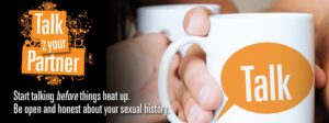 An image of a hand holding a mug. The image says "Talk 2 your Partner" and "start talking before things heat up. Be open and honest about your sexual history."