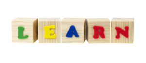 Wooden blocks with colourful letters on them that spell "Learn"